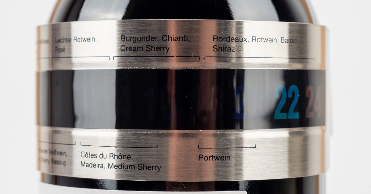 A stainless steel wine thermometer bracelet with a digital display showing the temperature of the wine in the bottle.
