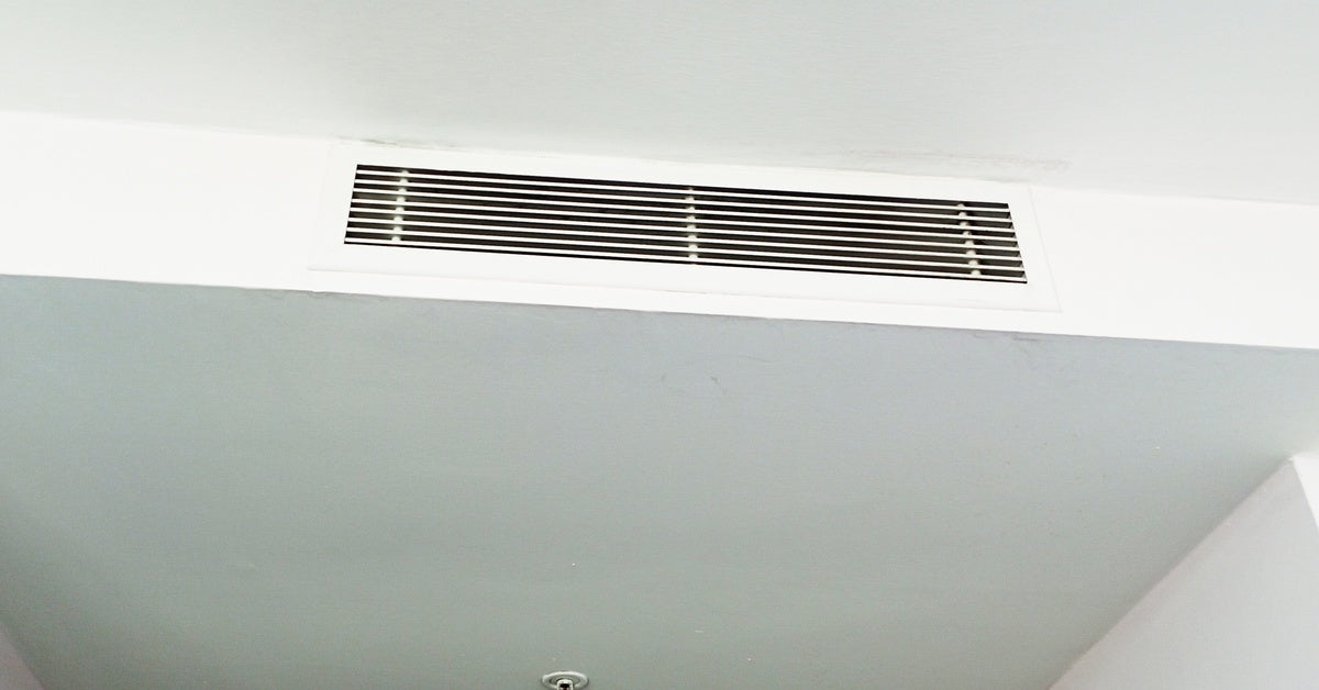 A ceiling air vent for a concealed mini-split system, showing a slim linear grille integrated cleanly into an interior ceiling.